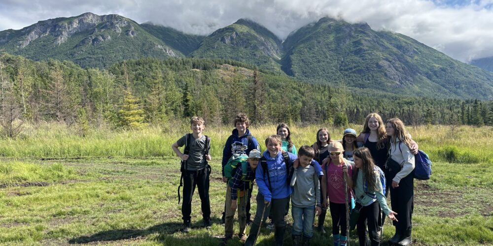 kids smiling with mountains